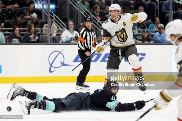Jack Eichel of the Vegas Golden Knights passes past Justin Schultz of the Seattle Kraken during the first period at Climate Pledge Arena on March 12,...