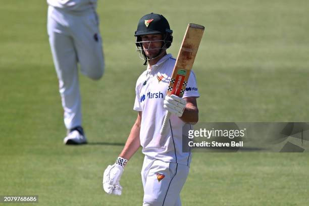 Beau Webster of the Tigers celebrates scoring a half century during the Sheffield Shield match between Tasmania and South Australia at Blundstone...
