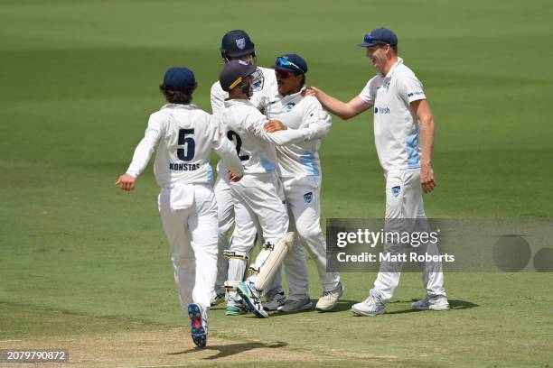 Oliver Davies of New South Wales celebrates taking a catch to dismiss Jack Clayton of Queensland during the Sheffield Shield match between Queensland...