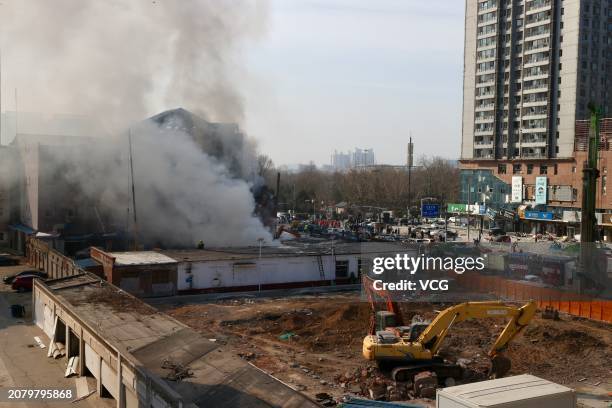 Smoke rises from buildings after an explosion occurred at 7:55 am at the residential community in Xiaozhangezhuang village of Yanjiao on March 13,...