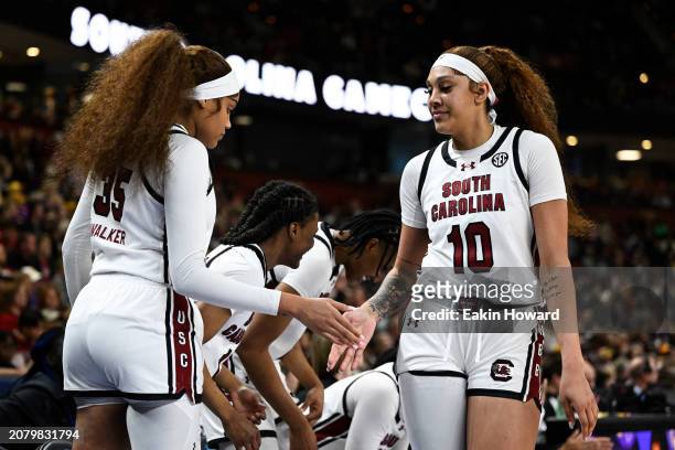 Kamilla Cardoso high fives Sakima Walker of the South Carolina Gamecocks after being substituted off the court against the LSU Lady Tigers in the...