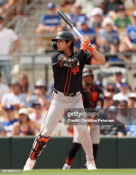 Jung Hoo Lee of the San Francisco Giants bats against the Los Angeles Dodgers during the first inning of the MLB spring game at Camelback Ranch on...