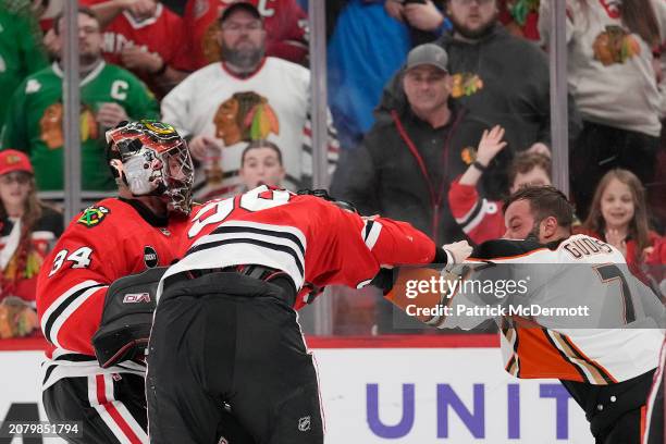Petr Mrazek of the Chicago Blackhawks and Radko Gudas of the Anaheim Ducks fight during the third period at the United Center on March 12, 2024 in...