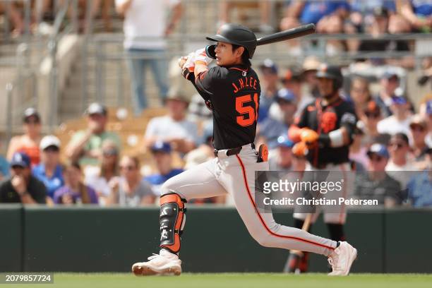 Jung Hoo Lee of the San Francisco Giants bats against the Los Angeles Dodgers during the first inning of the MLB spring game at Camelback Ranch on...