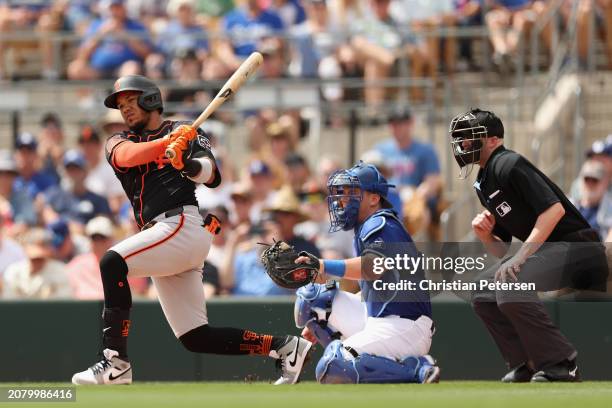 Thairo Estrada of the San Francisco Giants bats against the Los Angeles Dodgers during the first inning of the MLB spring game at Camelback Ranch on...