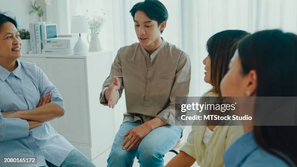 group of psychotherapists talking and discussing mental health problems. people use group therapy to support each other in recovering from the sadness. - promises rehab center foto e immagini stock