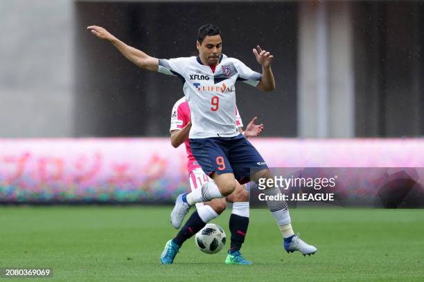 Diego Oliveira of FC Tokyo controls the ball against Yusuke Maruhashi of Cerezo Osaka during the J.League J1 match between Cerezo Osaka and FC Tokyo...