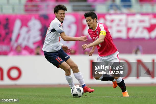 Hotaru Yamaguchi of Cerezo Osaka controls the ball against Kento Hashimoto of FC Tokyo during the J.League J1 match between Cerezo Osaka and FC Tokyo...