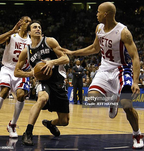 Emanuel Ginobili of the San Antonio Spurs drives to the basket past Kerry Kittles and Richard Jefferson of the New Jersey Nets during the second half...