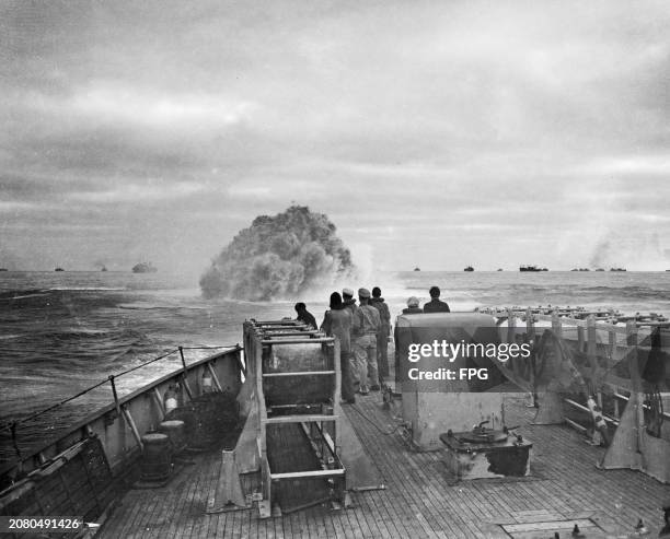 The crew of the United States Coast Guard Treasury-class cutter USCGC Spencer watch one of their depth charges explode as they defend the Liverpool...