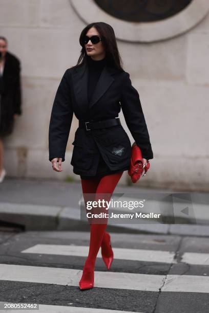 Pia Wurtzbach is seen wearing red tights, red leather heels, leather Gucci bag, Victoria Tomas black tailored belted blazer and black sunglasses...