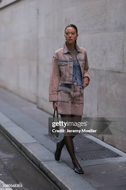 Guest is seen wearing a brown denim jeans jacket, matching jeans skirt, black tights, black leather bag, blue and white stripped vest, grey shirt and...
