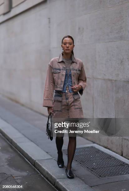 Guest is seen wearing a brown denim jeans jacket, matching jeans skirt, black tights, black leather bag, blue and white stripped vest, grey shirt and...