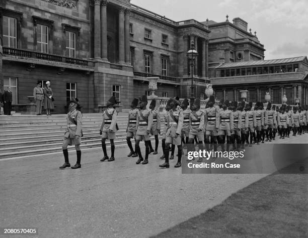 Queen Elizabeth II watches the King's African Rifles Regiment marching at Buckingham Palace, London, UK, 11th June 1957.