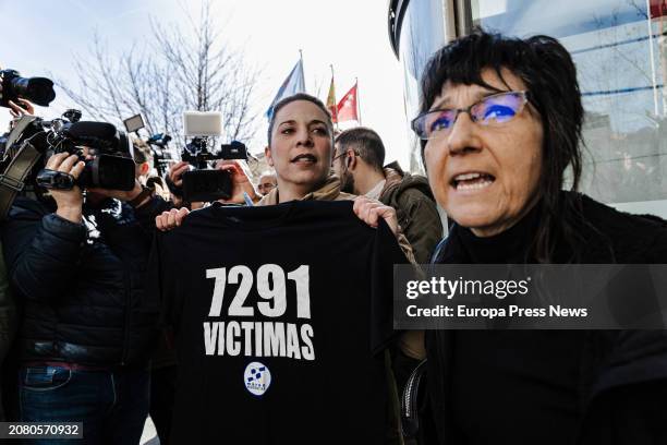 Two women protest with a T-shirt with the number of deaths during the COVID-19 pandemic in the residences of the Community of Madrid, in front of the...