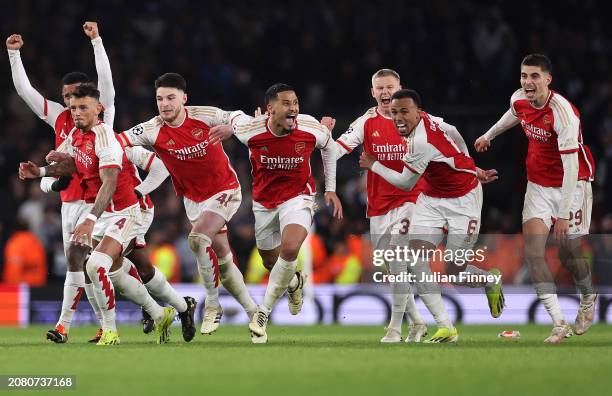 The players of Arsenal celebrate as David Raya of Arsenal makes the match-winning save from the fourth penalty from Galeno of FC Porto in the penalty...