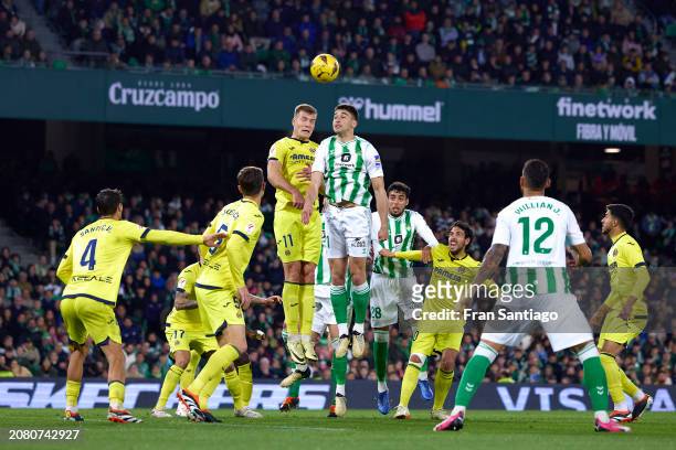 Marc Roca of Real Betis competes for the ball with Alexander Sorloth of Villarreal CF during the LaLiga EA Sports match between Real Betis and...