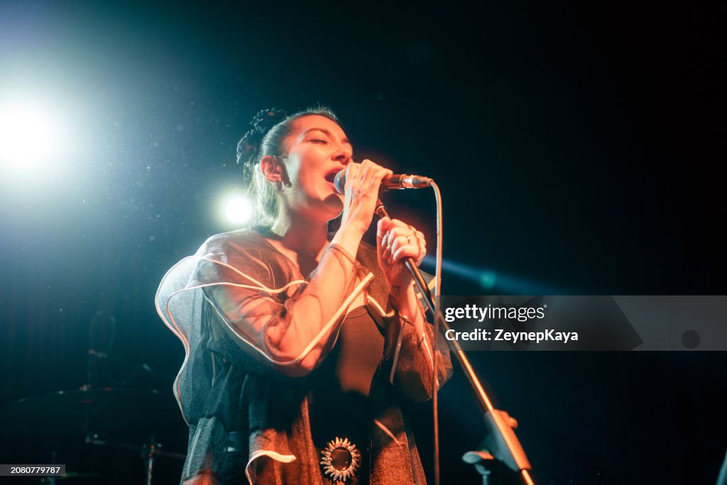 Singer of Music Band Performing on, stage light and smoke effects.