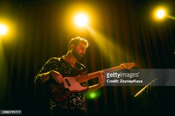 music band performing on, stage light and smoke effects. - bass instrument stock pictures, royalty-free photos & images