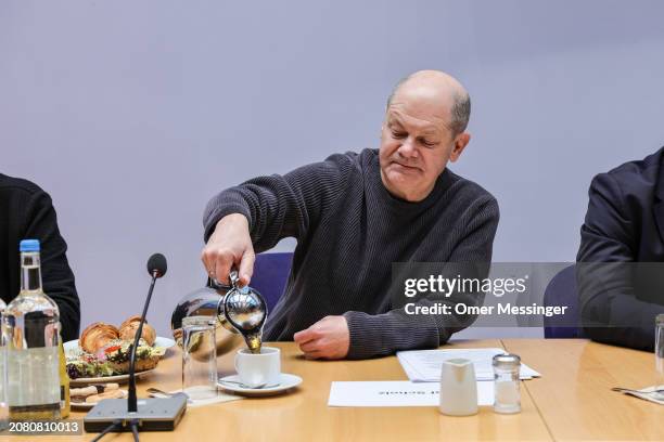 German Chancellor and member of the German Social Democrats Olaf Scholz pours himself coffee as he sits next to German Federal Minister for Housing,...