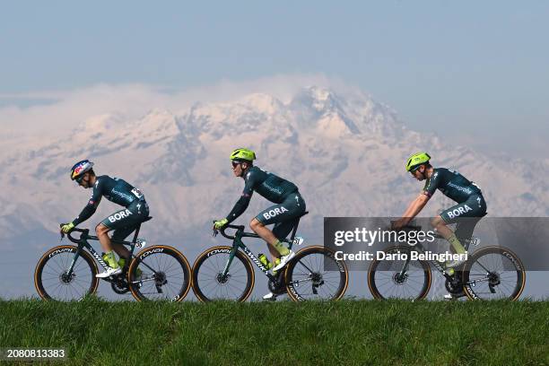 Anton Palzer of Germany, Bob Jungels of Luxembourg and Emil Herzog of Germany and Team BORA - hansgrohe compete with the Alps in the background...