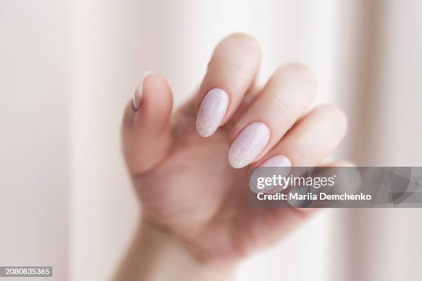 hand with beautiful manicure - pink gel nails with glitter - light pink nails stock pictures, royalty-free photos & images