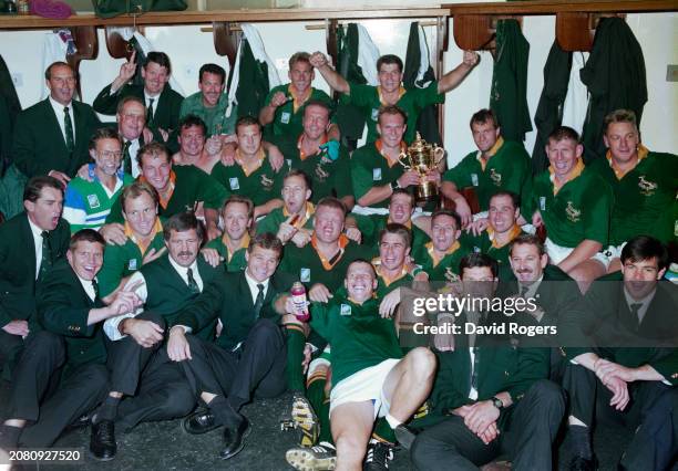 Springboks captain Francois Pienaar holds the trophy as his team mates celebrate in the dressing room after their 1995 Rugby World Cup Final victory...