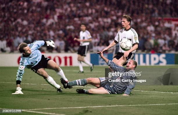 England player Paul Gascoigne just fails to convert a cross as Germany players Andreas Köpke and Steffen Freund look on during the 1996 UEFA European...