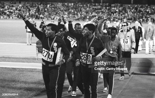 American athletes Lee Evans gives the Black Power Salute as he and Larry James of the United States lead the team off the track after the medal...