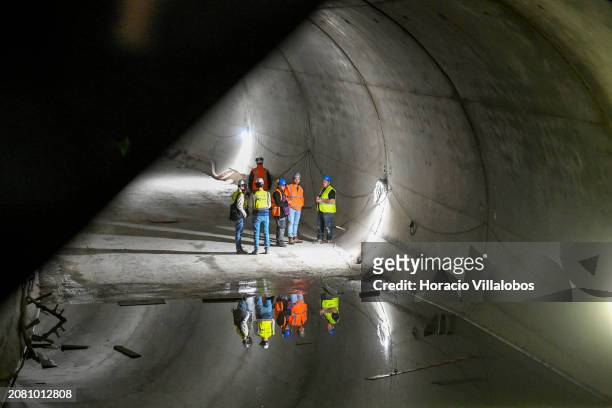 Metro personnel are seen standing at the opposite side of the tunnel connecting Santos to Rato through new Estrela and Santos stations, that are at...