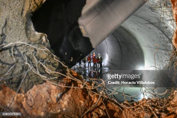 Metro personnel are seen standing at the opposite side of the opened tunnel connecting Santos to Rato through new Estrela and Santos stations, that...