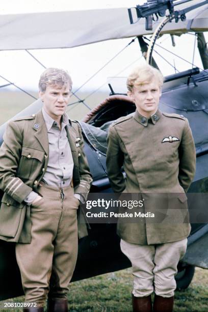 Actors Malcolm McDowell and Peter Firth pose for portraits during an interview on the set of the film, "Aces High," in Wycombe Air Park on September...