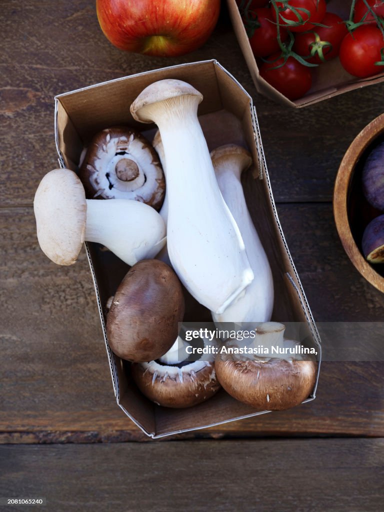 Top view seasonal vegetables and fruits, healthy vegetarian ingredients on a wooden background