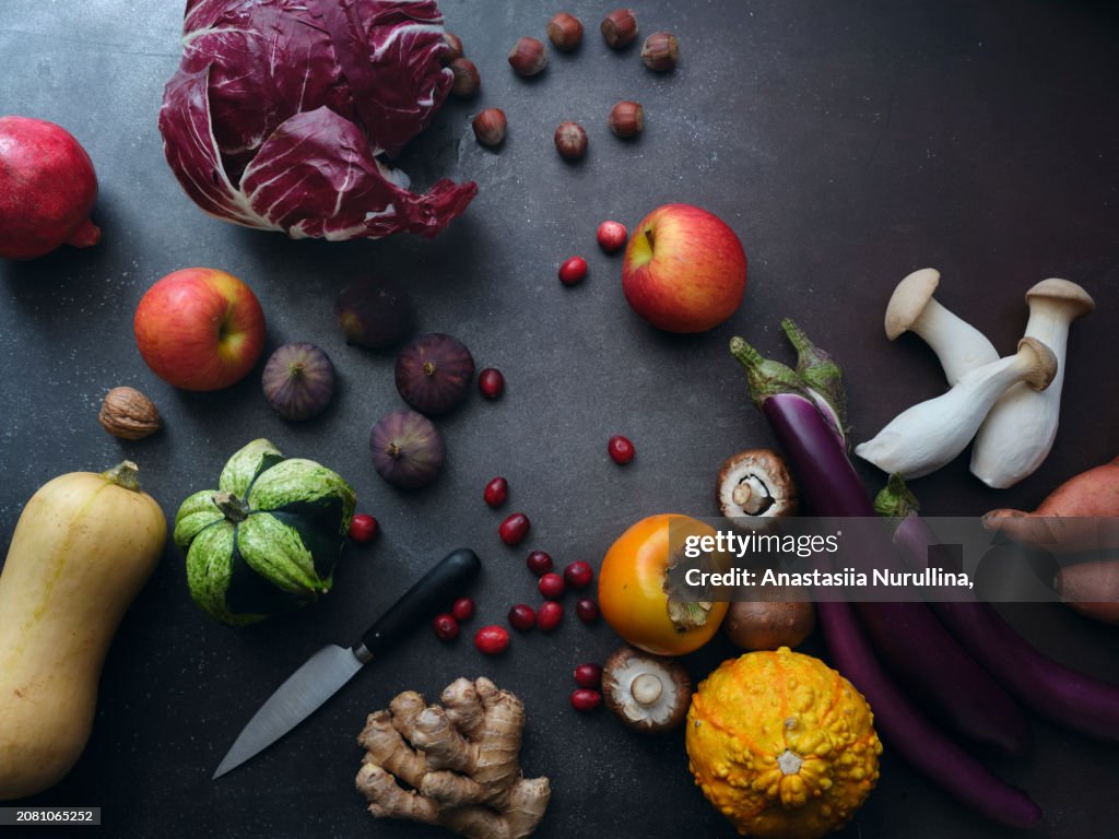 Top view seasonal groceries, healthy vegetarian ingredients on a dark background