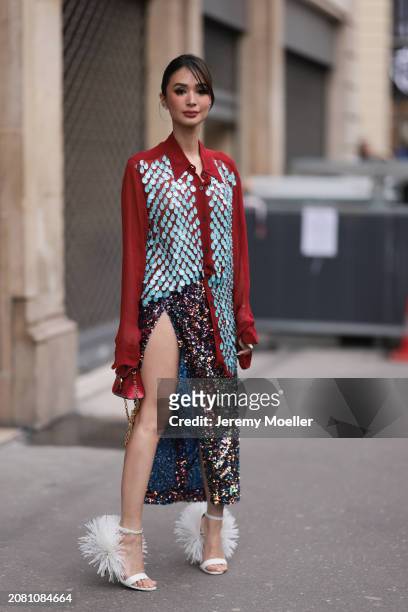 Heart Evangelista wears a red oversized shirt with blue and silver shiny sequins, a midi slit skirt in multi colored shiny sequins, white fluffy...