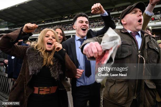 Race-goers celebrate Ballyburn's win in the Gallagher Novices' Hurdle Race on Style Wednesday, day two of the Cheltenham Festival at Cheltenham...