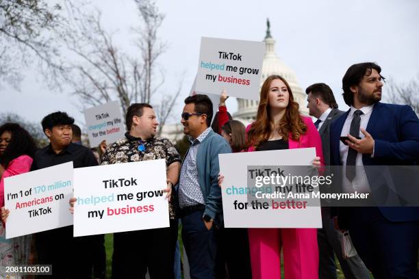 Participants hold signs in support of TikTok outside the U.S. Capitol Building on March 13, 2024 in Washington, DC. The House of Representatives will...