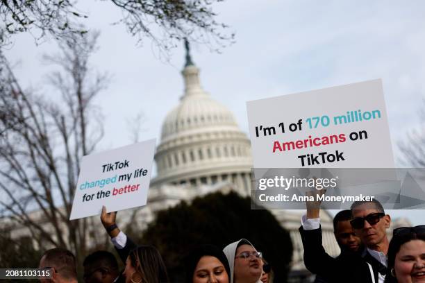 Participants hold signs in support of TikTok outside the U.S. Capitol Building on March 13, 2024 in Washington, DC. The House of Representatives will...