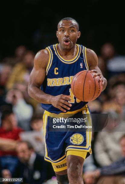 Tim Hardaway, Point Guard for the Golden State Warriors in motion dribbling the basketball down court during the NBA Midwest Division basketball game...