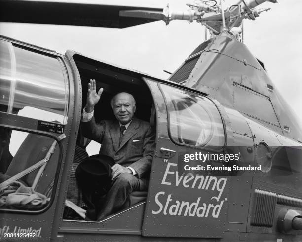 Max Aitken, 1st Baron Beaverbrook waving from a Westland WS-51 Dragonfly helicopter with 'Evening Standard' markings, July 21st 1953.