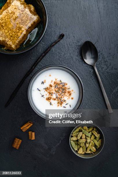 moon milk with cinnamon, honeycomb, lavender, cardamom, and vanilla - ashwagandha stock-fotos und bilder