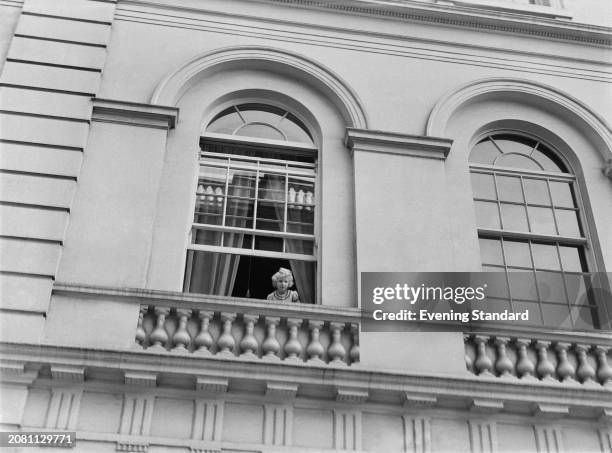 Princess Anne looks out of an open window at Clarence House, London, August 4th 1955. Queen Elizabeth The Queen Mother's birthday was the same day.