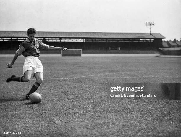 West Ham Football Club striker Harry Hooper Jnr kicking a ball during training, September 23rd 1955.
