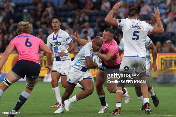 Waratahs' Dylan Pietsch tackles Blues' Mark Tele'a during the Super Rugby match between the NSW Waratahs and the Blues in Sydney on March 16, 2024. /...