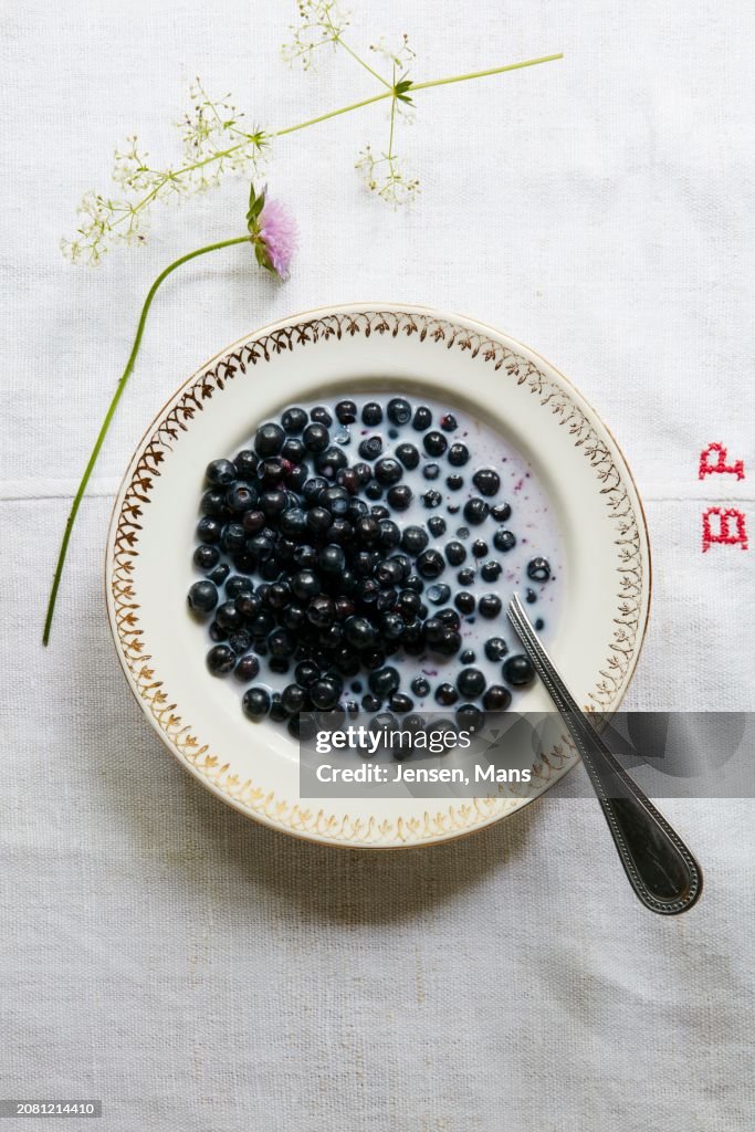 Blueberries with milk on linen