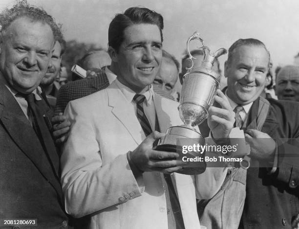 South African golfer Gary Player holds the Claret Jug trophy after winning the 1959 British Open Championship at Muirfield Golf Links in Gullane,...