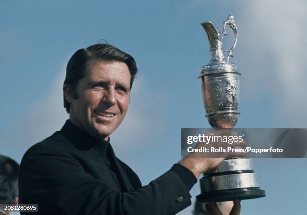 South African golfer Gary Player holds up the Claret Jug trophy after winning the 1974 British Open Championship at Royal Lytham & St Annes Golf Club...