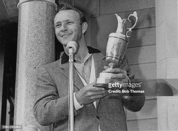 American golfer Arnold Palmer holds up the Claret Jug trophy after winning the 1962 British Open Championship at Troon Golf Club in Troon, South...