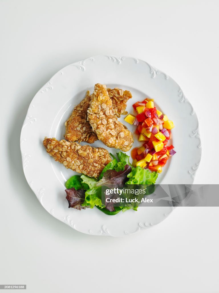Oat crust chicken with bell pepper and salad