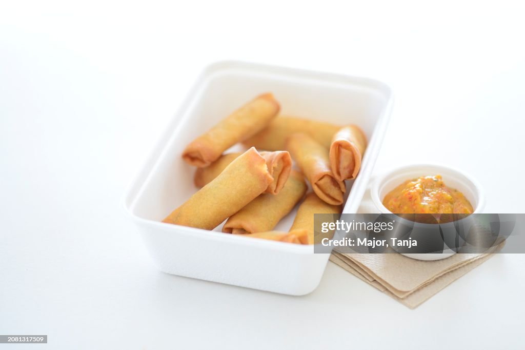 Spring rolls and a dip in take away cartons